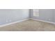 Neutral carpeted bedroom features a window that brings in natural light at 3313 Alhambra Cir, Hampton, GA 30228