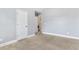 Neutral carpet in bedroom with view to the laundry room and closet at 3313 Alhambra Cir, Hampton, GA 30228