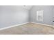Cozy bedroom with neutral carpet, a window providing natural light, and soothing light gray walls at 3313 Alhambra Cir, Hampton, GA 30228