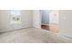 Bright, carpeted bedroom featuring a large window, with a view into the dining room at 3313 Alhambra Cir, Hampton, GA 30228