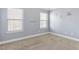 This carpeted bedroom features motivational wall decals and two windows that bring in natural light at 3313 Alhambra Cir, Hampton, GA 30228