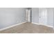 This carpeted bedroom has two white doors, light-grey walls, and white baseboards at 3313 Alhambra Cir, Hampton, GA 30228