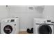 Bright laundry room featuring white Samsung washer and dryer plus white wire rack shelving for storage at 3313 Alhambra Cir, Hampton, GA 30228