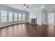 Bright living room with fireplace, tray ceiling, and large windows offering natural light at 3313 Alhambra Cir, Hampton, GA 30228