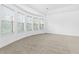 Bright and airy main bedroom boasting neutral carpet, many windows, and a tray ceiling at 3313 Alhambra Cir, Hampton, GA 30228