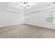 Spacious main bedroom with a tray ceiling, neutral carpet, and two bright windows at 3313 Alhambra Cir, Hampton, GA 30228
