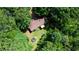 Aerial view of home surrounded by lush greenery, a wooden deck, and an inflatable pool in the backyard at 1638 River Trce, Auburn, GA 30011