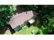 Aerial view of two-story home with a deck surrounded by a lush lawn and greenery at 1638 River Trce, Auburn, GA 30011