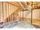 Unfinished basement showing utilities, support beams, and concrete floor, offering potential for customization at 1638 River Trce, Auburn, GA 30011