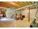 Unfinished basement showing utilities, support beams, and concrete floor, offering potential for customization at 1638 River Trce, Auburn, GA 30011
