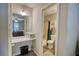 Bathroom and vanity area featuring tile floor, mirror, white storage shelf, and shower-tub combination at 1638 River Trce, Auburn, GA 30011