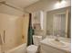 Bathroom featuring a shower-tub combo with curtain, commode, and sink with vanity and mirror at 1638 River Trce, Auburn, GA 30011
