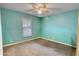 Virtually staged bedroom showcasing a large window providing natural light with neutral paint and carpet at 1638 River Trce, Auburn, GA 30011