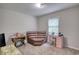 Bedroom with neutral walls featuring a brown leather lounging couch and small desk at 1638 River Trce, Auburn, GA 30011