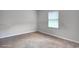 Neutral bedroom is virtually staged with carpeting and natural light from the window at 1638 River Trce, Auburn, GA 30011