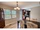 Bright dining area featuring a modern chandelier, view of nature, and access to outdoor area at 1638 River Trce, Auburn, GA 30011