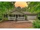 Charming ranch-style home with a covered front porch, attached garage, and inviting curb appeal at 1638 River Trce, Auburn, GA 30011