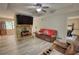 Inviting living room featuring a stone fireplace, modern ceiling fan, and wood-look flooring at 1638 River Trce, Auburn, GA 30011
