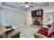 Cozy living room with stone fireplace, ceiling fan, and durable light-colored flooring at 1638 River Trce, Auburn, GA 30011
