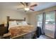 Main bedroom with a ceiling fan, large bed with white linens, and a window that offers natural light at 1638 River Trce, Auburn, GA 30011
