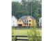 A partially constructed two-story home showcases its architectural design, with a black fence bordering the expansive front yard at 2002 Freestone Way, Marietta, GA 30064