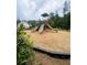 A community playground features multiple slides and climbing structures, set on a wood-chip surface at 2002 Freestone Way, Marietta, GA 30064