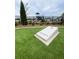 A concrete cornhole game on artificial turf is set near a playground, offering fun recreational options for residents at 2002 Freestone Way, Marietta, GA 30064