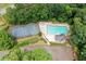 Aerial view of community pool, tennis courts, and parking surrounded by mature trees at 2605 Woodland Hills Dr, Cumming, GA 30040