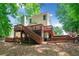 Expansive backyard features multi-level wooden decks and stairs with a view of the surrounding trees at 2605 Woodland Hills Dr, Cumming, GA 30040