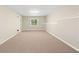 Spacious carpeted basement with a window and neutral-colored walls at 2605 Woodland Hills Dr, Cumming, GA 30040