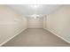 Finished basement with neutral carpet, drop ceiling, and base trim throughout at 2605 Woodland Hills Dr, Cumming, GA 30040