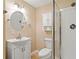 Well-lit bathroom with vanity, toilet, cabinet, and shower with modern fixtures at 2605 Woodland Hills Dr, Cumming, GA 30040