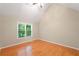 Cozy bedroom featuring a large window with natural light and hardwood floors at 2605 Woodland Hills Dr, Cumming, GA 30040
