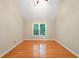 Inviting bedroom featuring hardwood floors and a large window offering scenic views at 2605 Woodland Hills Dr, Cumming, GA 30040