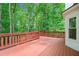 Wooden deck with lush greenery, a perfect outdoor space for relaxation and entertainment at 2605 Woodland Hills Dr, Cumming, GA 30040