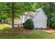 Side view of home with lush landscaping, green shutters, and wood deck at 2605 Woodland Hills Dr, Cumming, GA 30040