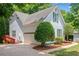 View of home with garage, small porch, and manicured landscaping at 2605 Woodland Hills Dr, Cumming, GA 30040