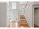 Grand foyer with hardwood floors, staircase, and natural light from large windows at 2605 Woodland Hills Dr, Cumming, GA 30040