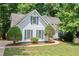 Charming two-story home with beautiful lawn, lush landscaping, and green shutters at 2605 Woodland Hills Dr, Cumming, GA 30040