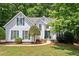 Charming two-story home with beautiful lawn, lush landscaping, and green shutters at 2605 Woodland Hills Dr, Cumming, GA 30040