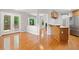 Open living space with hardwood floors, and a view into the kitchen and deck at 2605 Woodland Hills Dr, Cumming, GA 30040
