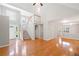 Bright open-concept living area showcasing hardwood floors, staircase, and abundant natural light at 2605 Woodland Hills Dr, Cumming, GA 30040