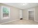 Neutral-toned room with tile flooring, access to outdoor deck, and adjacent room at 2605 Woodland Hills Dr, Cumming, GA 30040