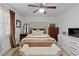 Cozy bedroom with a tufted headboard, wood furniture, and light-colored walls at 3147 Buford Ne Hwy # 8, Brookhaven, GA 30329