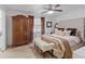 Comfortable bedroom featuring a bed with tufted headboard and a large wooden wardrobe at 3147 Buford Ne Hwy # 8, Brookhaven, GA 30329