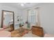 Bright home office with a glass desk, pink chairs, and built-in shelving at 3147 Buford Ne Hwy # 8, Brookhaven, GA 30329