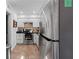 Bright kitchen with stainless steel refrigerator and appliances, white cabinets, and tile flooring at 3147 Buford Ne Hwy # 8, Brookhaven, GA 30329