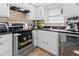 Well-lit kitchen featuring white cabinetry, stainless steel appliances, and sleek countertops at 3147 Buford Ne Hwy # 8, Brookhaven, GA 30329