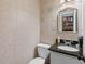 Small powder room with unique wall tiles, granite countertops and modern fixtures at 3147 Buford Ne Hwy # 8, Brookhaven, GA 30329
