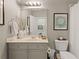 Bright bathroom featuring a neutral color palette, vanity with framed mirror, and classic fixtures at 4298 Kingston Gate Cv, Chamblee, GA 30341